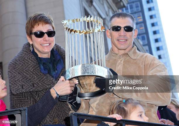 New York Yankees Manager Joe Girardi and wife Kimberly Girardi hold up the World Series Trophy at the 2009 New York Yankees World Series Victory...