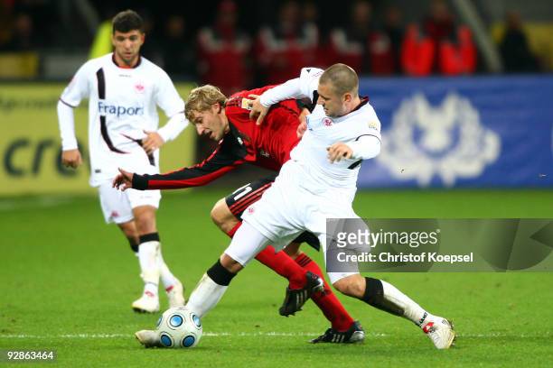 Marco Russ of Frankfurt tackles Stefan Kiessling of Leverkusen during the Bundesliga match between Bayer Leverkusen and Eintracht Frankfurt at the...