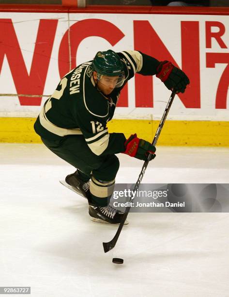 Chuck Kobasew of the Minnesota Wild handles the puck against the Chicago Blackhawks at the United Center on October 26, 2009 in Chicago, Illinois....