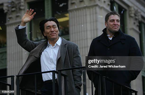 Hideki Matsui and Eric Hinske of the New York Yankees celebrate on a float during the New York Yankees World Series Victory Parade on November 6,...