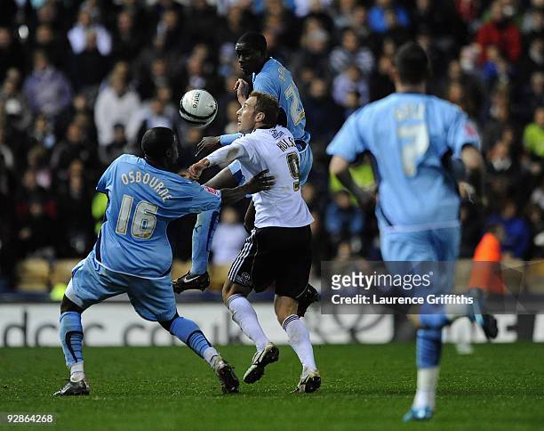Rob Hulse of Derby battles with Isaac Osbourne and Leon Barrett of Coventry during the Coca-Cola Championship match between Derby County and Coventry...