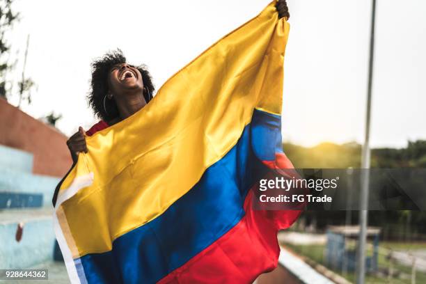 colombian fan watching a soccer game - columbian stock pictures, royalty-free photos & images