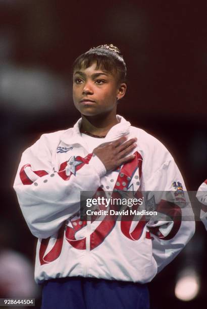 Dominique Dawes of the United States listens to the national anthem during the awards presentations at the Budget Rent A Car Invitational Gymnastics...