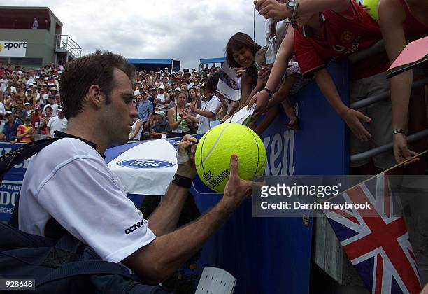 Greg Rusedski of Great Britain signs autographs for fans after his win over Lars Burgsmuller of Germany, in the third round of the Australian Open...