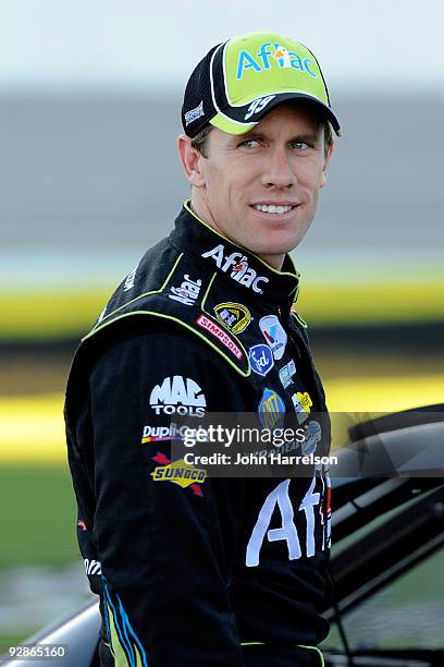 Carl Edwards, driver of the Aflac Ford, stands on pit road during qualifying for the NASCAR Sprint Cup Series Dickies 500 at Texas Motor Speedway on...