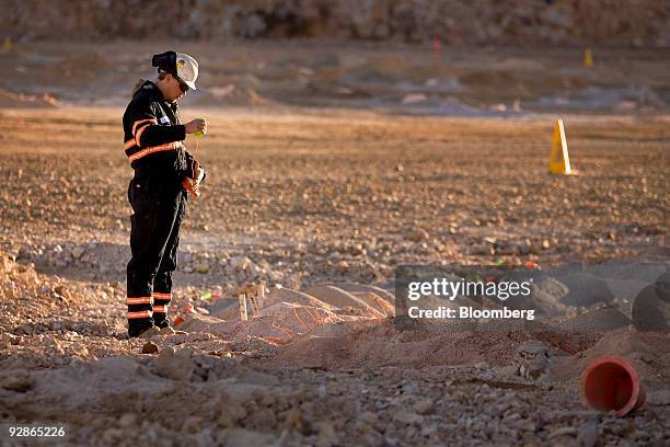 Joe Derby puts a booster into a pre-split blast hole at the AngloGold Ashanti Ltd. Cripple Creek & Victor gold mine in Victor/Cripple Creek,...