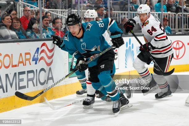 Joonas Donskoi of the San Jose Sharks chases the puck ahead of Duncan Keith and David Kampf of the Chicago Blackhawks at SAP Center on March 1, 2018...