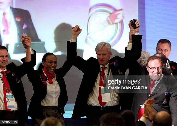 Members of the Canadian sports delegation celebrate the result of the final vote of the Pan American Sports Organization in Guadalajara, Mexico, on...