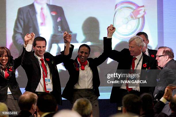 Members of the Canadian sports delegation celebrate the result of the final vote of the Pan American Sports Organization in Guadalajara, Mexico, on...