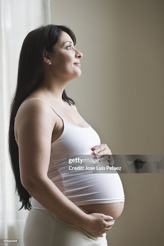 Pregnant woman holding her belly