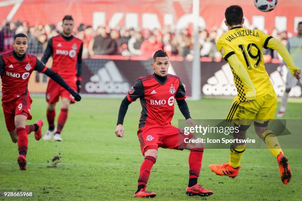 Toronto FC Defender Gregory van der Wiel and teammate Defender Auro watch Columbus Crew SC Defender Milton Valenzuela head the ball during the MLS...