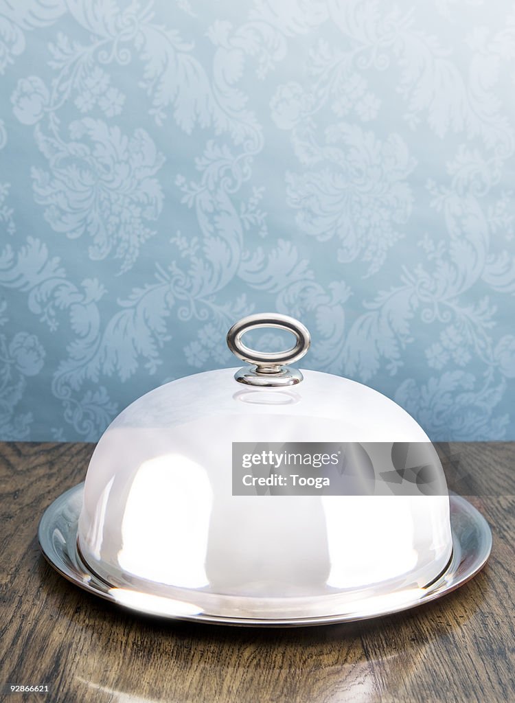 Silver coved serving dish on dining table