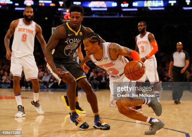 Trey Burke of the New York Knicks in action against Jordan Bell of the Golden State Warriors at Madison Square Garden on February 26, 2018 in New...