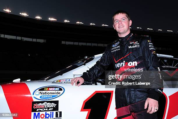 Justin Allgaier, driver of the Verizon Dodge, stands on pit road during qualifying for the NASCAR Nationwide Series O'Reilly Challenge at Texas Motor...