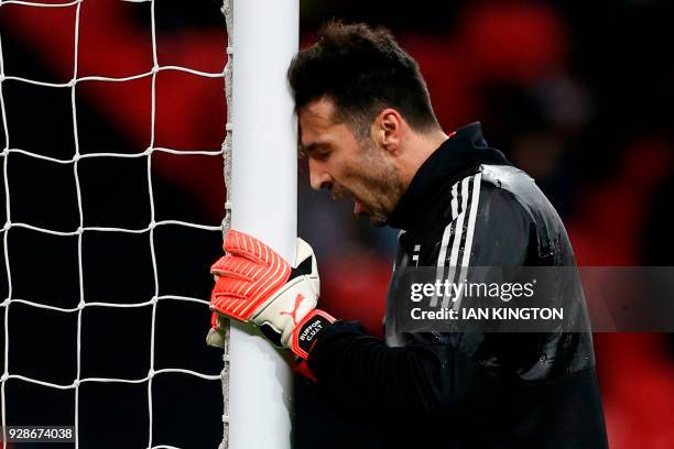 Juventus' Italian goalkeeper Gianluigi Buffon warms up for the UEFA Champions League round of sixteen second leg football match between Tottenham...