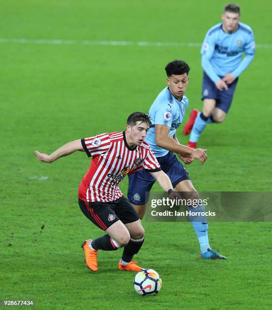 Michael Newbury of Newcastle chases down Lynden Gooch of Sunderland during the Premier League International Cup match between Sunderland U23 and...