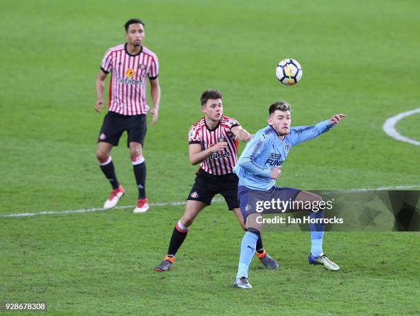 Luke Chapman of Newcastle is marked by Brandon Taylor of Sunderland during the Premier League International Cup match between Sunderland U23 and...