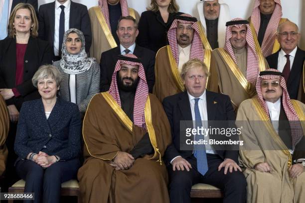 Theresa May, U.K. Prime minister, left, and Mohammed bin Salman, Saudi Arabia's crown prince, center, sit for a photograph ahead of a meeting inside...