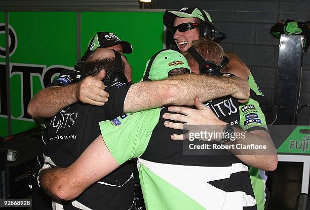 Crew members for Jason Bright driver of the Britek Motorsport Ford celebrate after Bright took pole position for race 21 for round 12 of the V8...