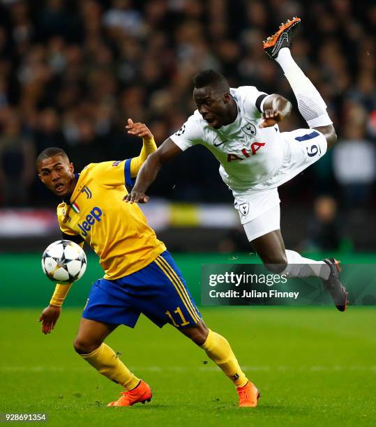 Douglas Costa of Juventus battle for the balls with Davinson Sanchez of Tottenham Hotspur during the UEFA Champions League Round of 16 Second Leg...