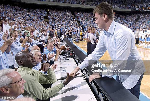 Indiana Pacers Tyler Hansbrough shakes hands with former NBA basketball player Michael Jordan before North Carolina Alumni Game at Dean Smith Center....
