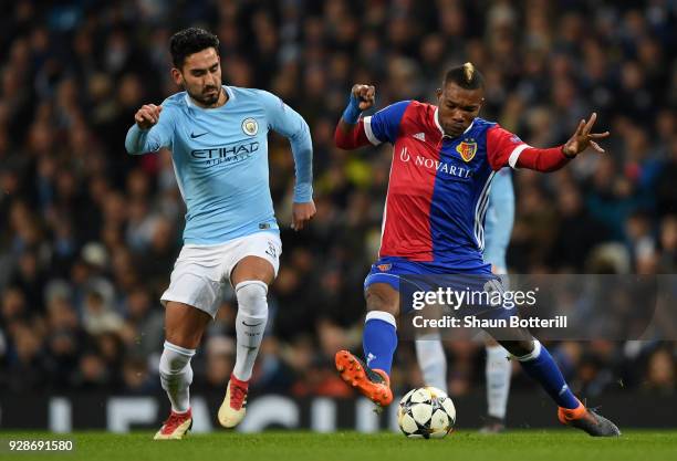 Geoffroy Serey Die of FC Basel holds off pressure from Ilkay Gundogan of Manchester City during the UEFA Champions League Round of 16 Second Leg...