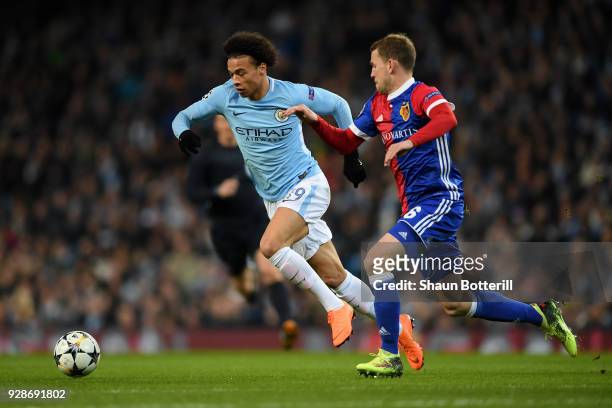 Leroy Sane of Manchester City skips past the tackle of Fabian Frei of FC Basel during the UEFA Champions League Round of 16 Second Leg match between...