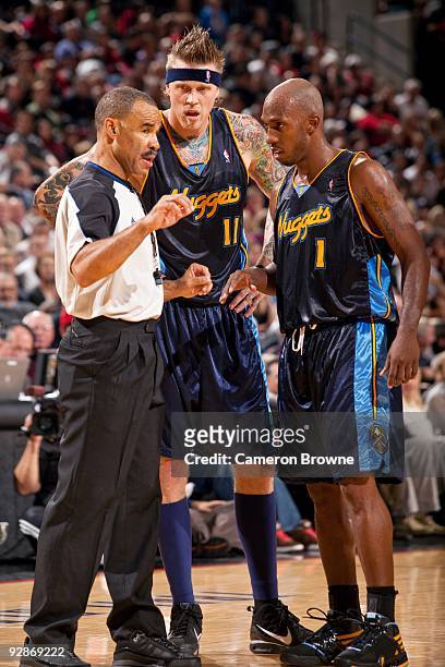 Chauncey Billups and Chris Andersen of the Denver Nuggets talk with referee Dan Crawford during the game against the Portland Trail Blazers at The...