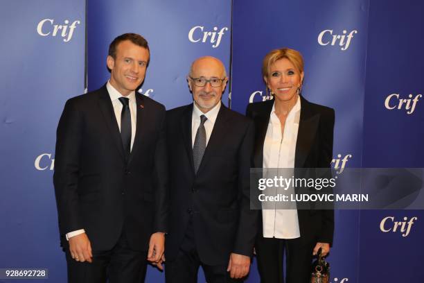 French President Emmanuel Macron, CRIF president Francis Kalifat and French president's wife Brigitte Macron pose as they attend the 33rd annual...