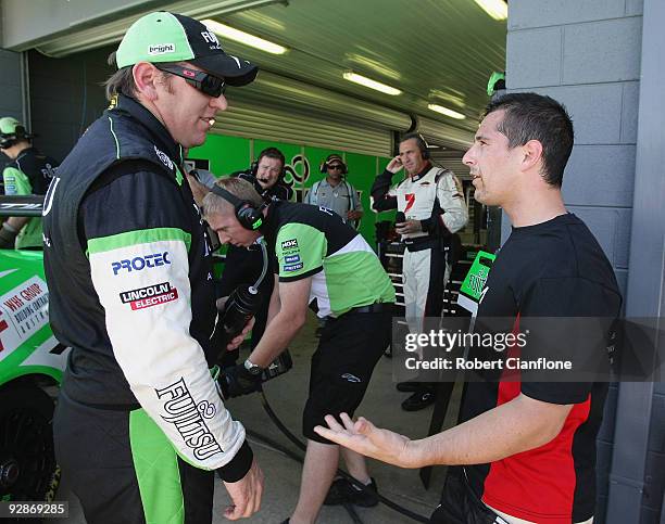 Jason Bright driver of the Britek Motorsport Ford and Michael Caruso driver of the Garry Rogers Motorsport Holden exchange words after the qualifying...