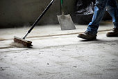 Worker Sweeping Up at Construction Site