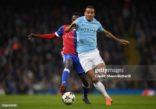 Danilo of Manchester City holds off pressure from Geoffroy Serey Die of FC Basel during the UEFA Champions League Round of 16 Second Leg match...