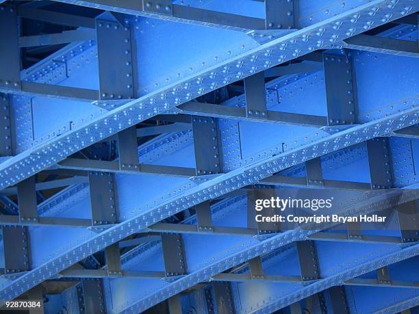 geometric under side of a blue bridge - metal rivets stock pictures, royalty-free photos & images