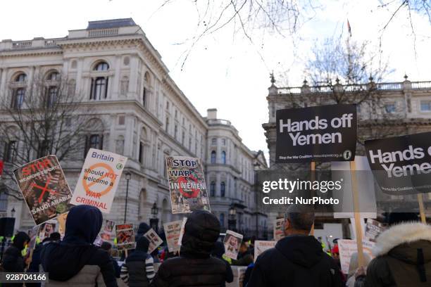 Demonstrators protest against Saudi Crown Prince Mohammed bin Salman, as he visits Downing Street, London on March 7, 2018. Protesters hold placards...