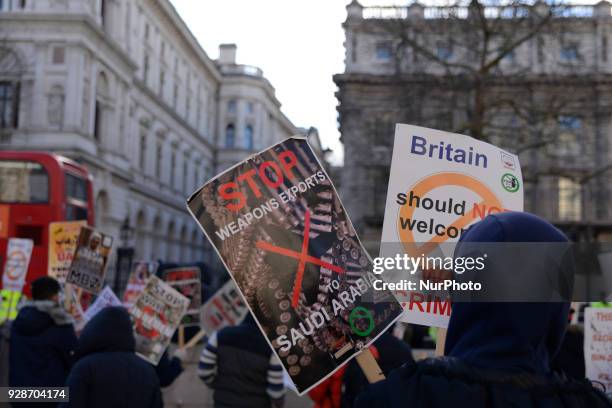 Demonstrators protest against Saudi Crown Prince Mohammed bin Salman, as he visits Downing Street, London on March 7, 2018. Protesters hold placards...