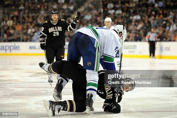 Ryan Kesler of the Vancouver Canucks falls on top of Stephane Robidas of the Dallas Stars during NHL action at American Airlines Center on November...