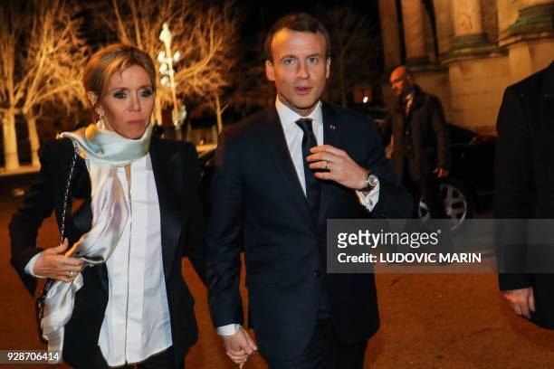 French President Emmanuel Macron and his wife Brigitte Macron arrive to attend the 33rd annual dinner of the Representative Council of Jewish...
