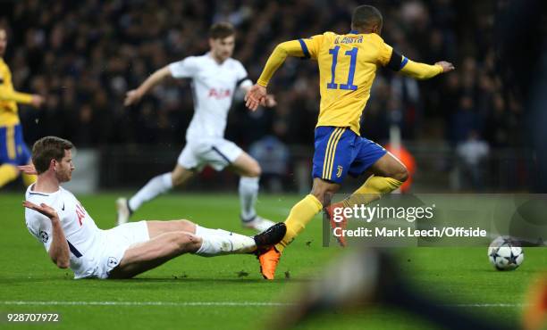 Jan Vertonghen of Tottenham slide tackles Douglas Costa of Juventus in the box but a penalty is not given for the challenge during the UEFA Champions...