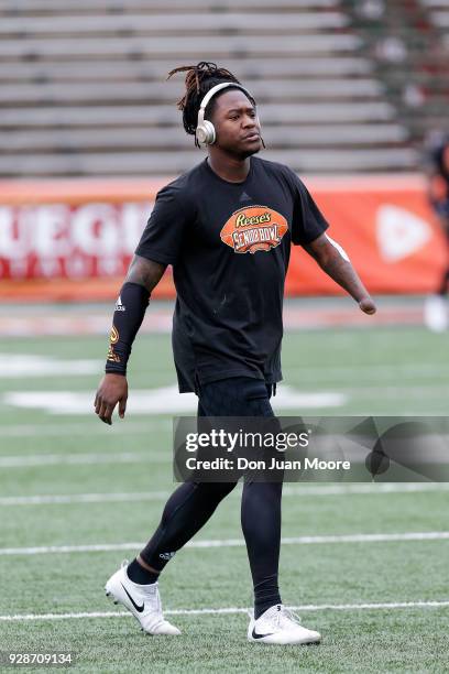 Linebacker Shaquem Griffin from Central Florida on the South Team warms up while listening to music through BEATS headphones before the start of the...