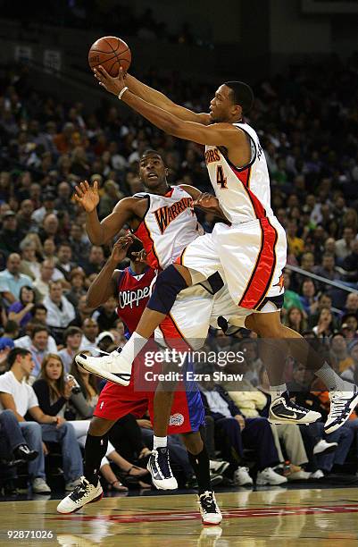 Anthony Randolph of the Golden State Warriors grabs a loose ball over Kelenna Azubuike during their game against the Los Angeles Clippers at Oracle...