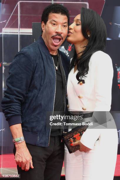 Lionel Richie and Lisa Parigi attend the Lionel Richie Hand And Footprint Ceremony at TCL Chinese Theatre on March 7, 2018 in Hollywood, California.