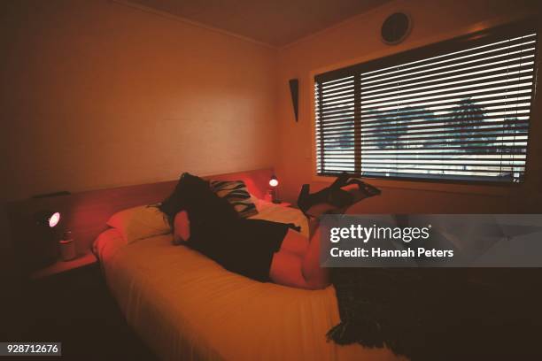 Sex worker rests on the bed following the successful booking from a regular client at The Bach, an ethical escort service, on May 25, 2017 in...