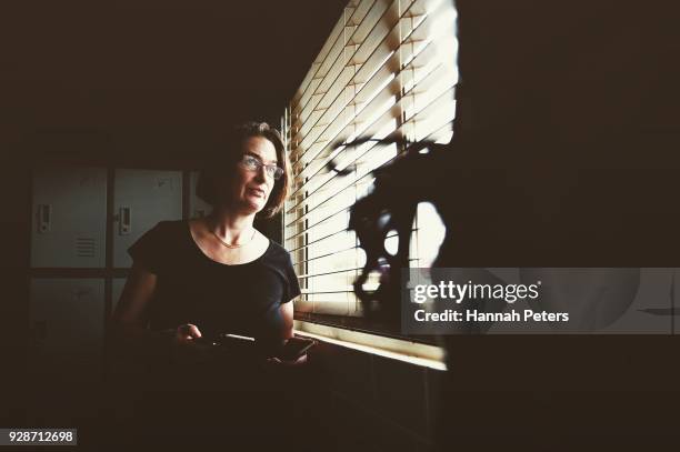 Brothel owner and director Antonia Murphy checks on the arrival of a client and safety of one of her ladies through her office window at The Bach, an...