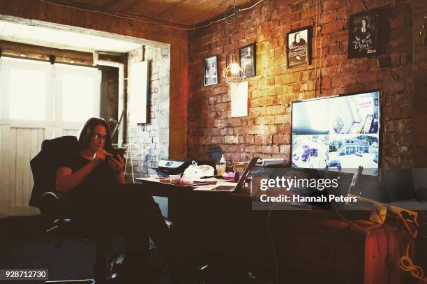 Brothel owner and director Antonia Murphy takes another booking on her phone in her office at The Bach, an ethical escort service, on October 19,...