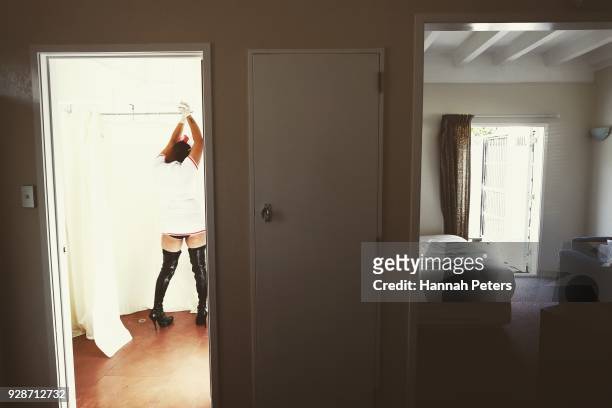 Sex worker waits ahead of her next booking at The Bach, an ethical escort service, on October 19, 2017 in Whangarei, New Zealand. Brothel Madame...