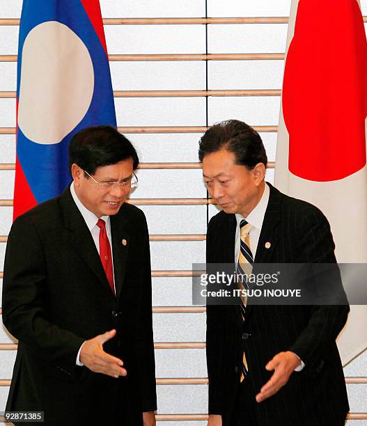Laotian Prime Minister Bouasone Bouphavanh is welcomed by Japanese Prime Minister Yukio Hatoyama prior to their meeting at the official residence in...