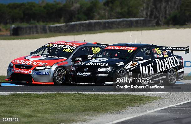 Craig Lowndes driver of the Team Vodafone Ford tangles with Todd Kelly driver of the Kelly Racing Holden during race 21 in round 12 of the V8...