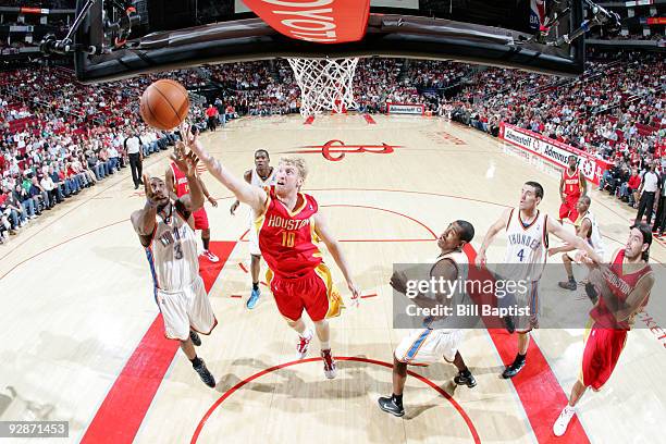 Chase Budinger of the Houston Rockets shoots the ball over D. J. White of the Oklahoma City Thunder on November 6, 2009 at the Toyota Center in...