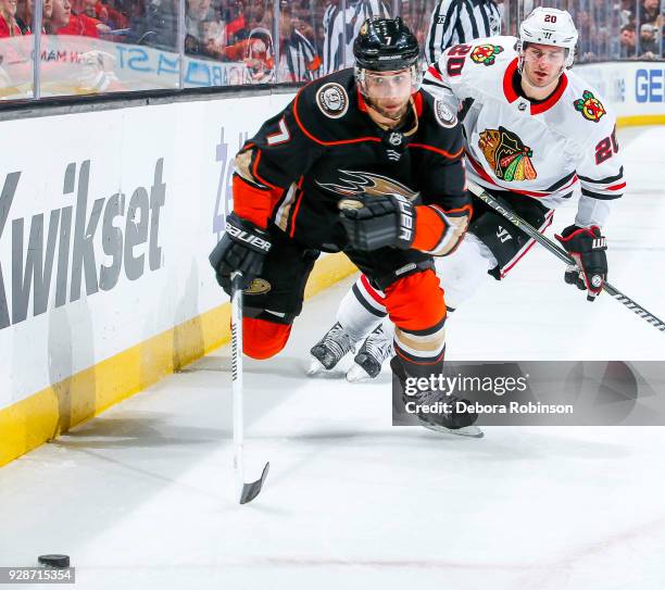 Andrew Cogliano of the Anaheim Ducks and Brandon Saad of the Chicago Blackhawks race for the puck during the first period of the game at Honda Center...