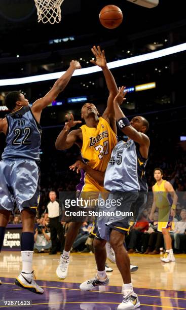 Ron Artest of the Los Angeles Lakers shoots over Steven Hunter and Rudy Gay of the Memphis Grizzlies on November 6, 2009 at Staples Center in Los...